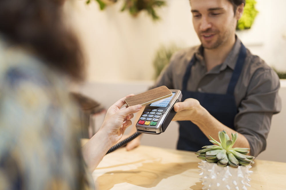 Cannabis Retail - Man holding Point of Sale Terminal