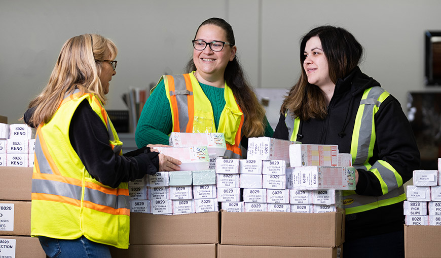 Three women in the AGLC warehouse