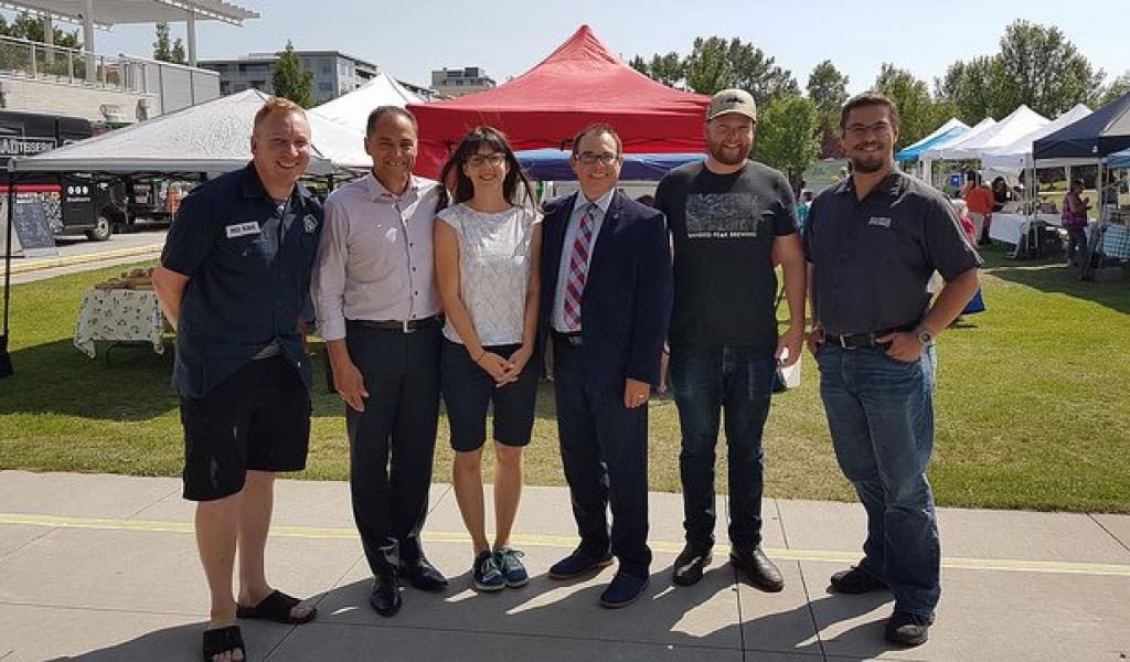 The Honourable Joe Ceci & Alain Maisonneuve (AGLC) celebrate new opportunities for Alberta's small liquor manufacturers at approved Alberta farmers' markets.