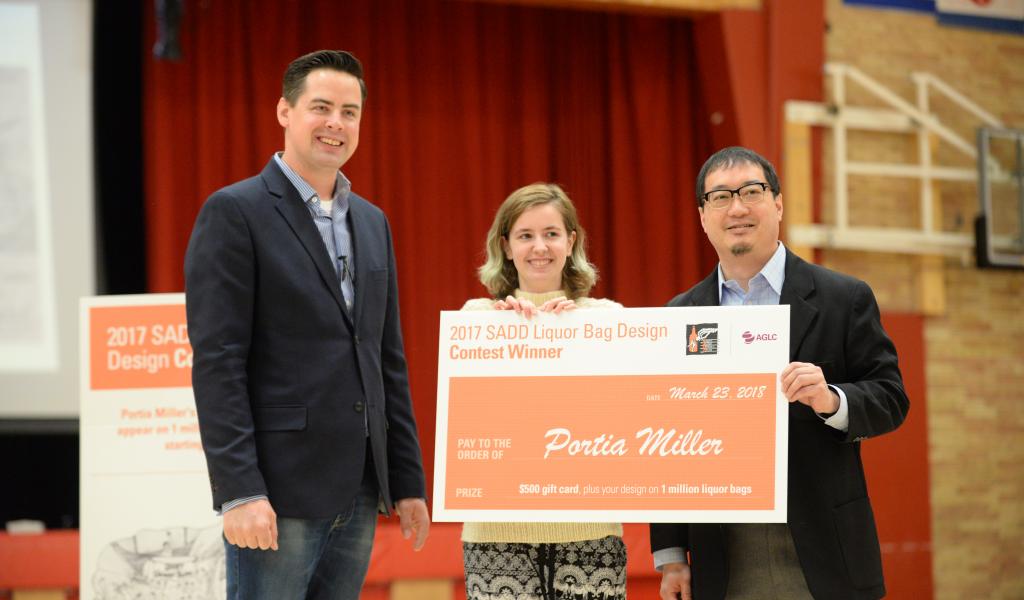 SADD Alberta Community Liaison, Arthur Lee and AGLC Communications Officer, Dan Huang congratulates Portia Miller, the 2017 Overall Winner for SADD Alberta's Liquor Bag Design Contest