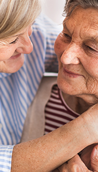 Two senior women embracing each other