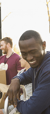 People passing on boxes out of truck